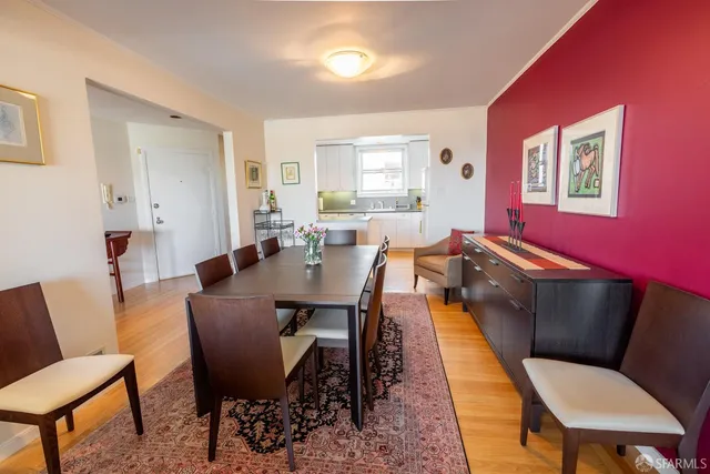 a dining room with furniture a rug and a window