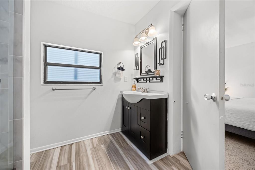 936 Santa Cruz Road Cocoa Beach, FL 32931 - Photo 12 of 45 a bathroom with a sink vanity and mirror