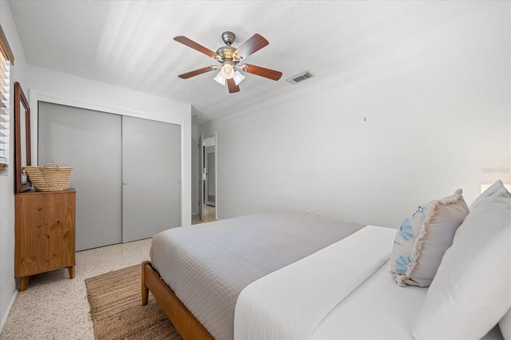 936 Santa Cruz Road Cocoa Beach, FL 32931 - Photo 14 of 45 a bedroom with a bed and a chandelier