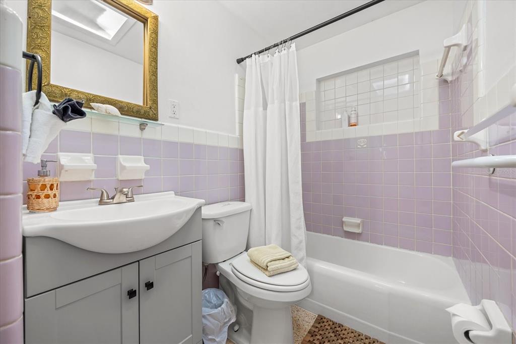 936 Santa Cruz Road Cocoa Beach, FL 32931 - Photo 15 of 45 a bathroom with a sink a toilet and a mirror