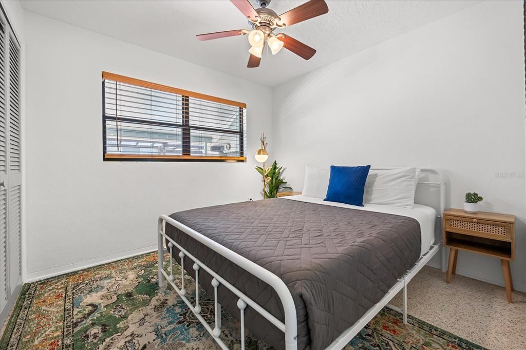 936 Santa Cruz Road Cocoa Beach, FL 32931 - Photo 16 of 45 a bedroom with a bed and a chandelier