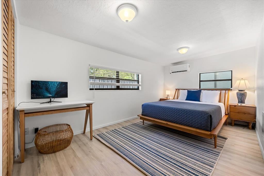 936 Santa Cruz Road Cocoa Beach, FL 32931 - Photo 17 of 45 a bedroom with furniture and a flat screen tv