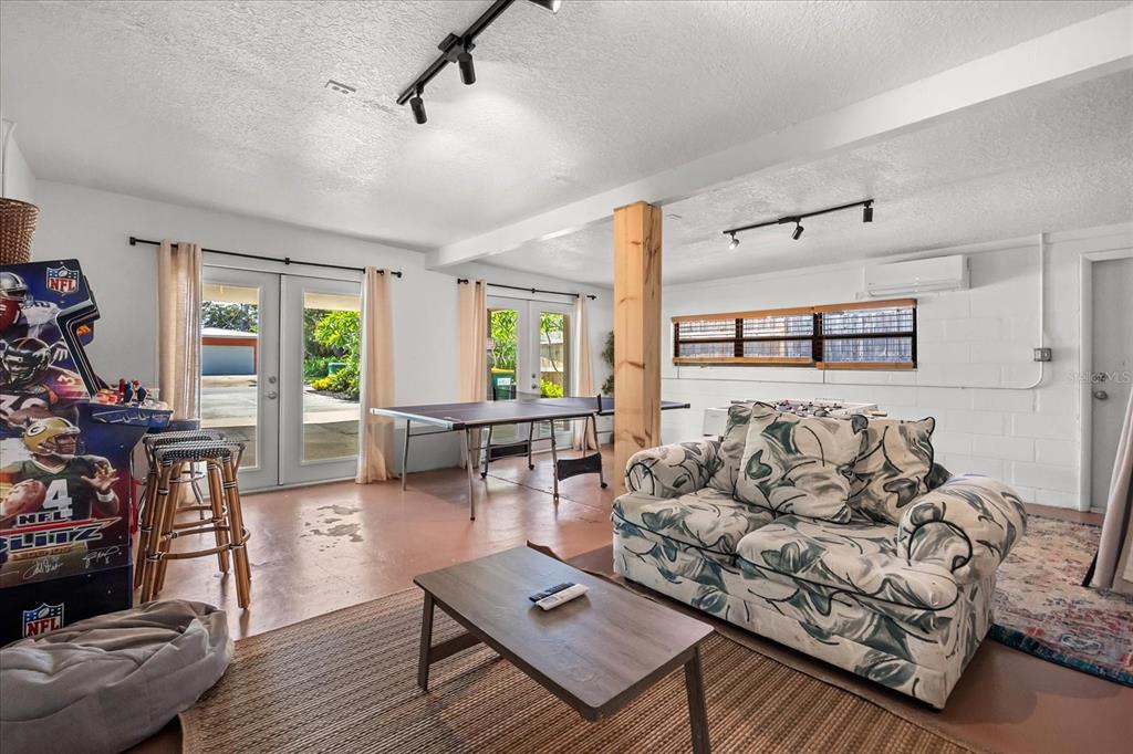 936 Santa Cruz Road Cocoa Beach, FL 32931 - Photo 23 of 45 a living room with furniture and a flat screen tv