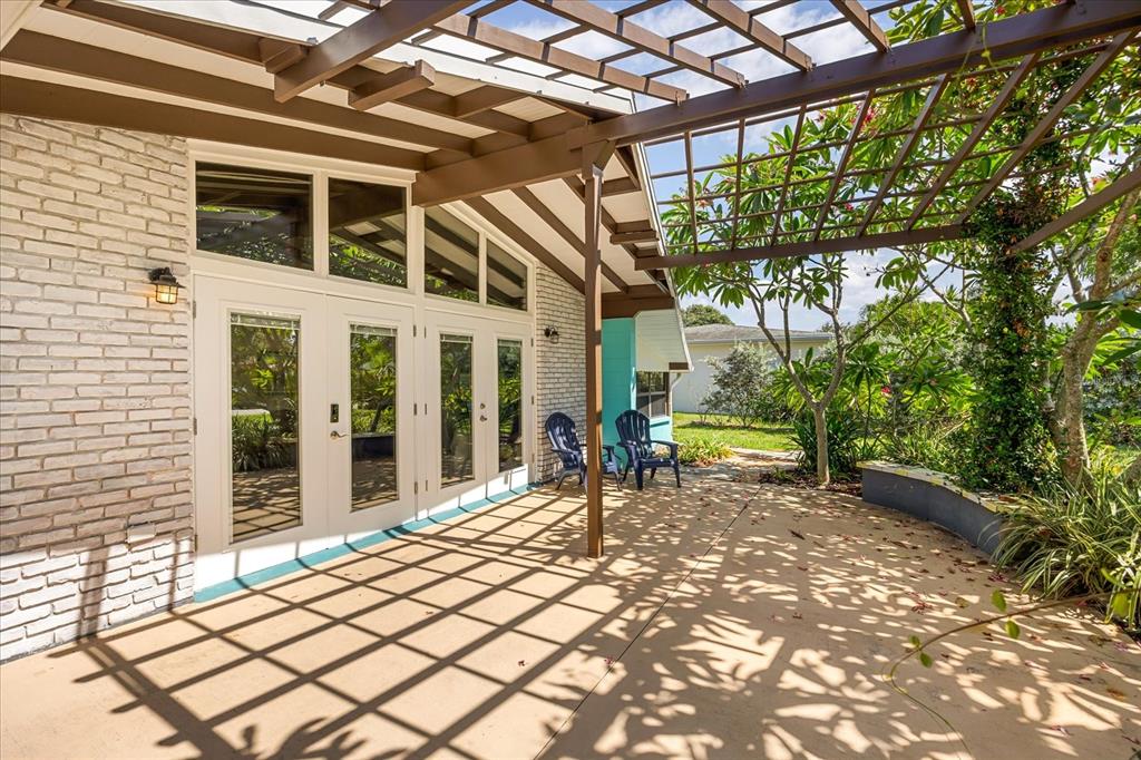 936 Santa Cruz Road Cocoa Beach, FL 32931 - Photo 28 of 45 a blue bench sitting in front of a building