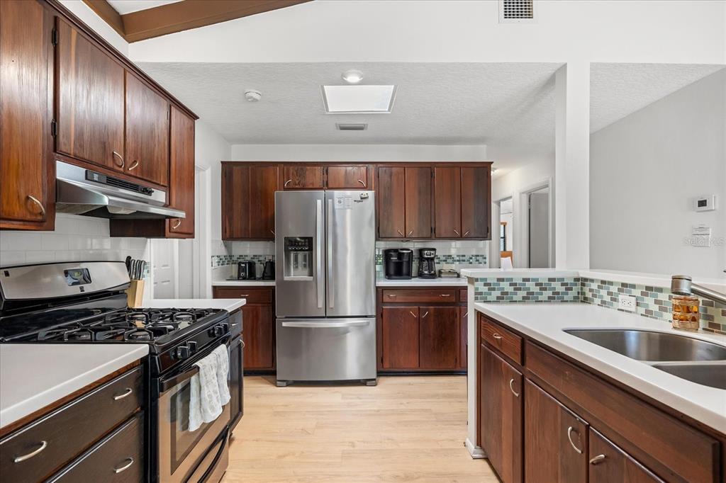 936 Santa Cruz Road Cocoa Beach, FL 32931 - Photo 7 of 45 a kitchen with a sink stove and refrigerator