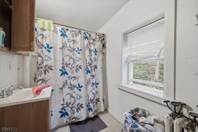 a bathroom with a bathtub and shower curtain