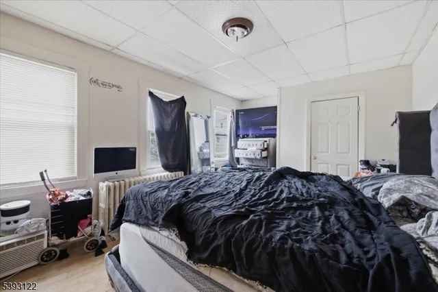 a bed room with a bed and a television