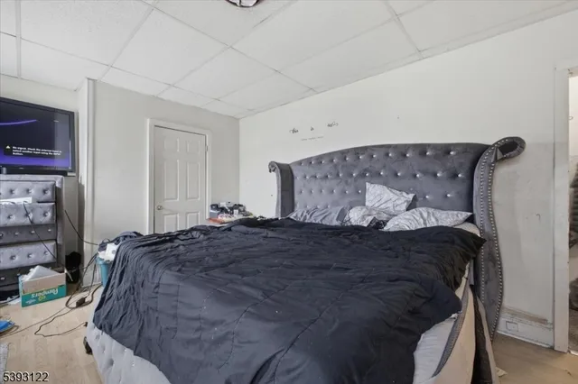 a bed sitting in a bedroom next to a tv