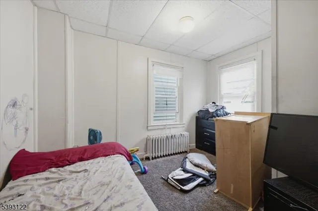 a bedroom with a bed and windows