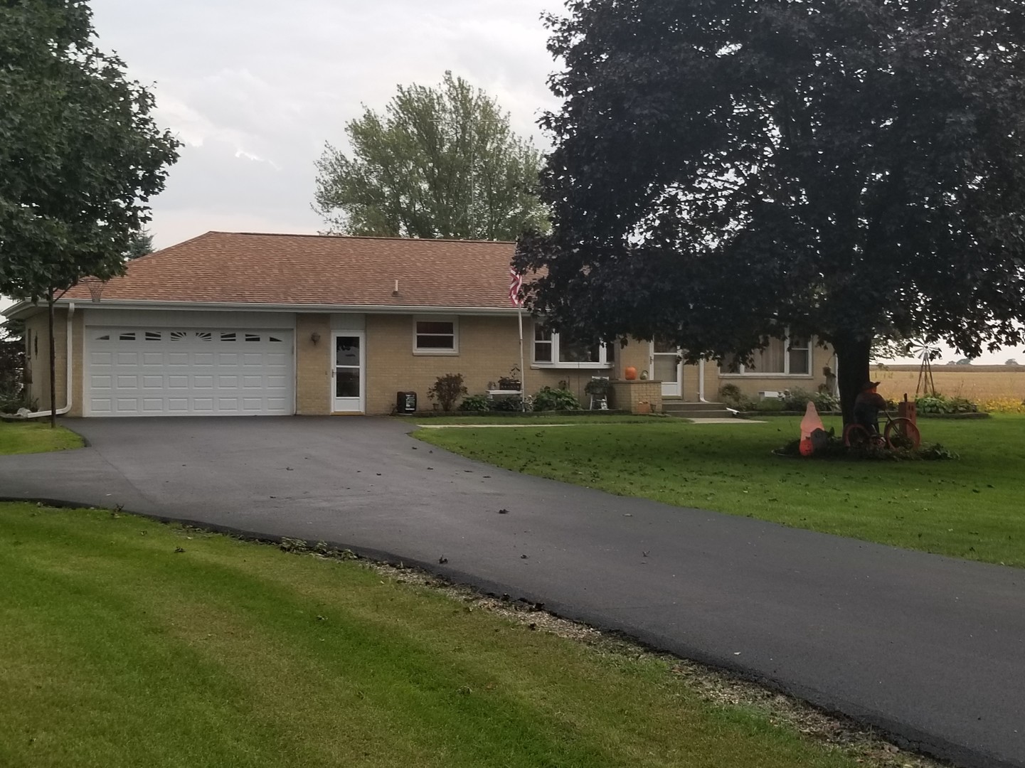 18869 Star Road Prophetstown, IL 61277 - Photo 1 of 20 a front view of a house with a garden and trees