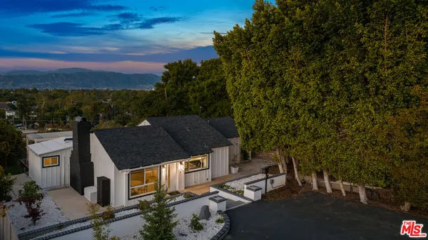 an aerial view of a house with a yard