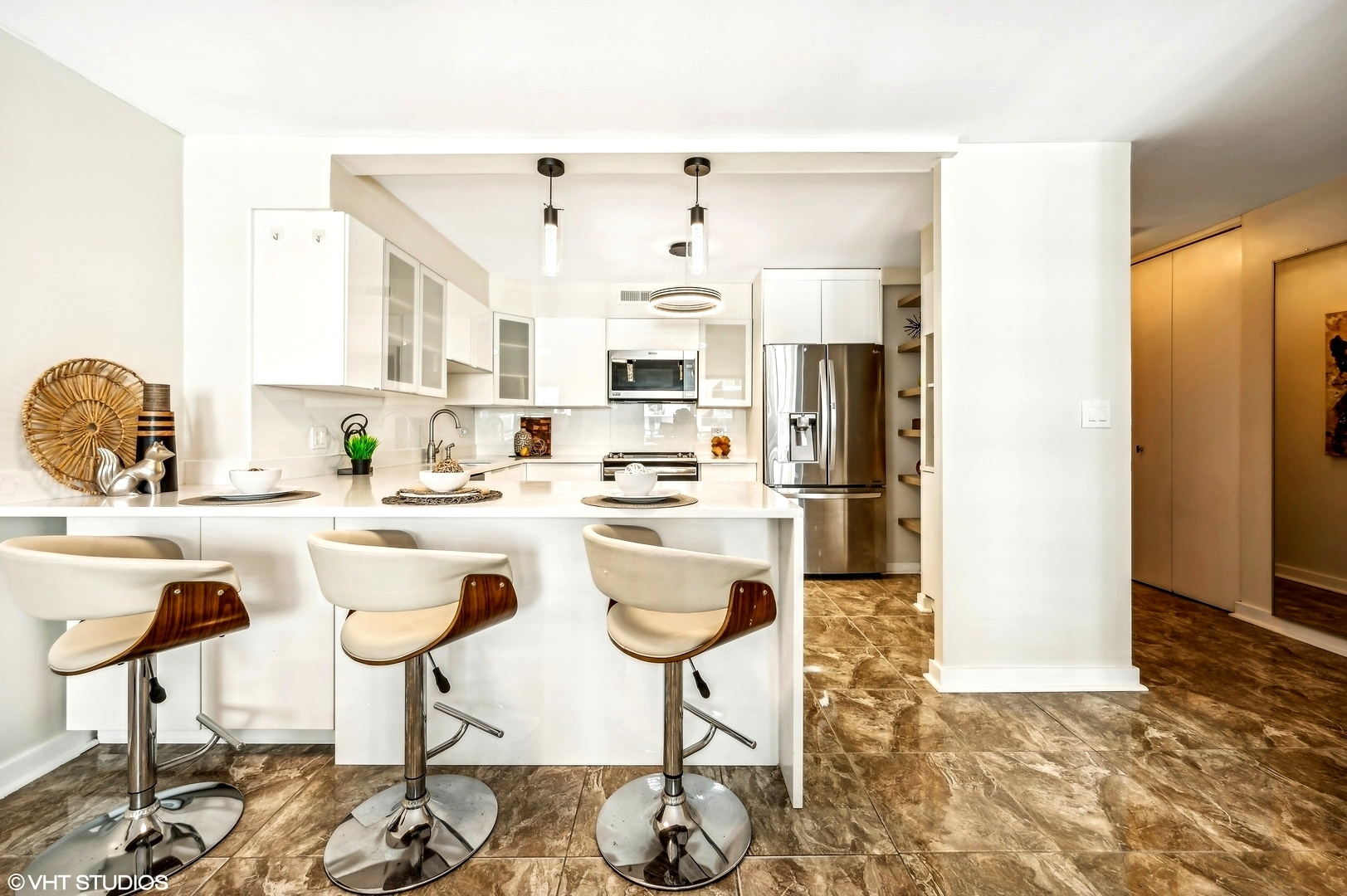 6007 North Sheridan Road, Unit 21F Chicago, IL 60660 - Photo 6 of 22 a kitchen with stainless steel appliances granite countertop a refrigerator and a stove top oven