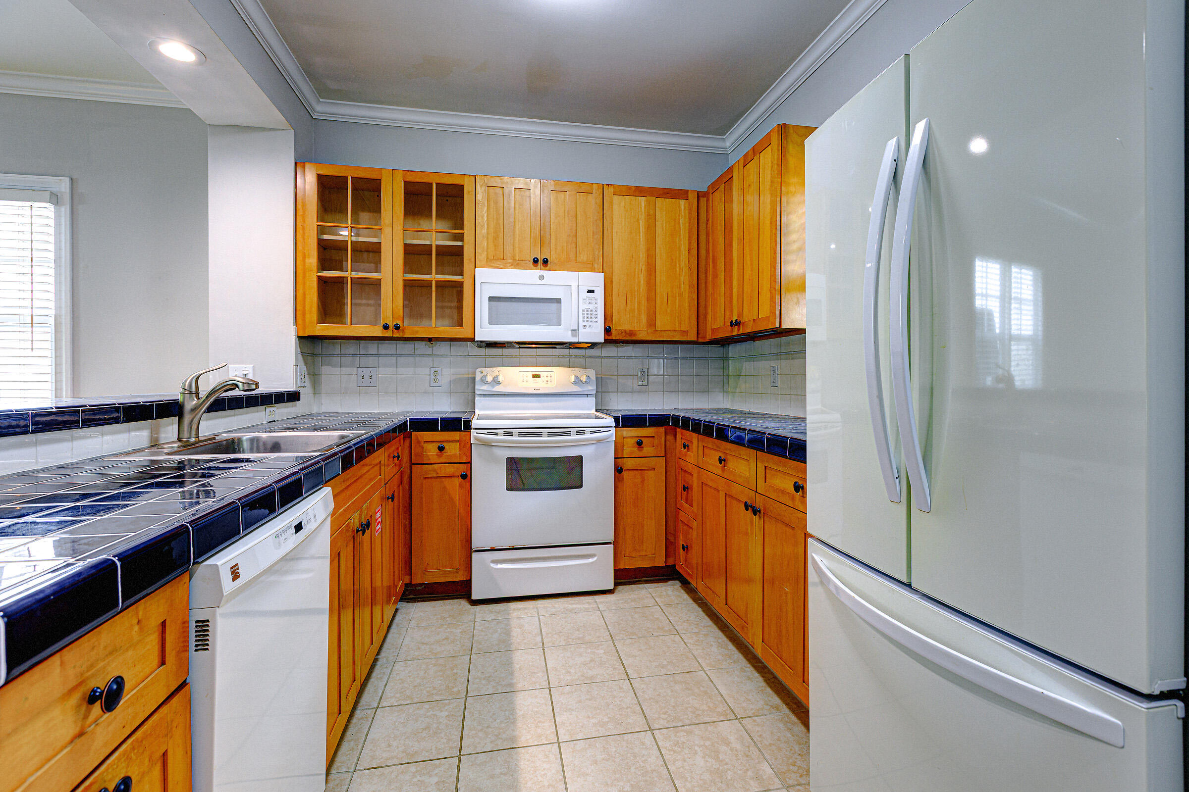 263 Golf Club Drive Key West, FL 33040 - Photo 4 of 30 a kitchen with stainless steel appliances granite countertop a stove a sink and a refrigerator