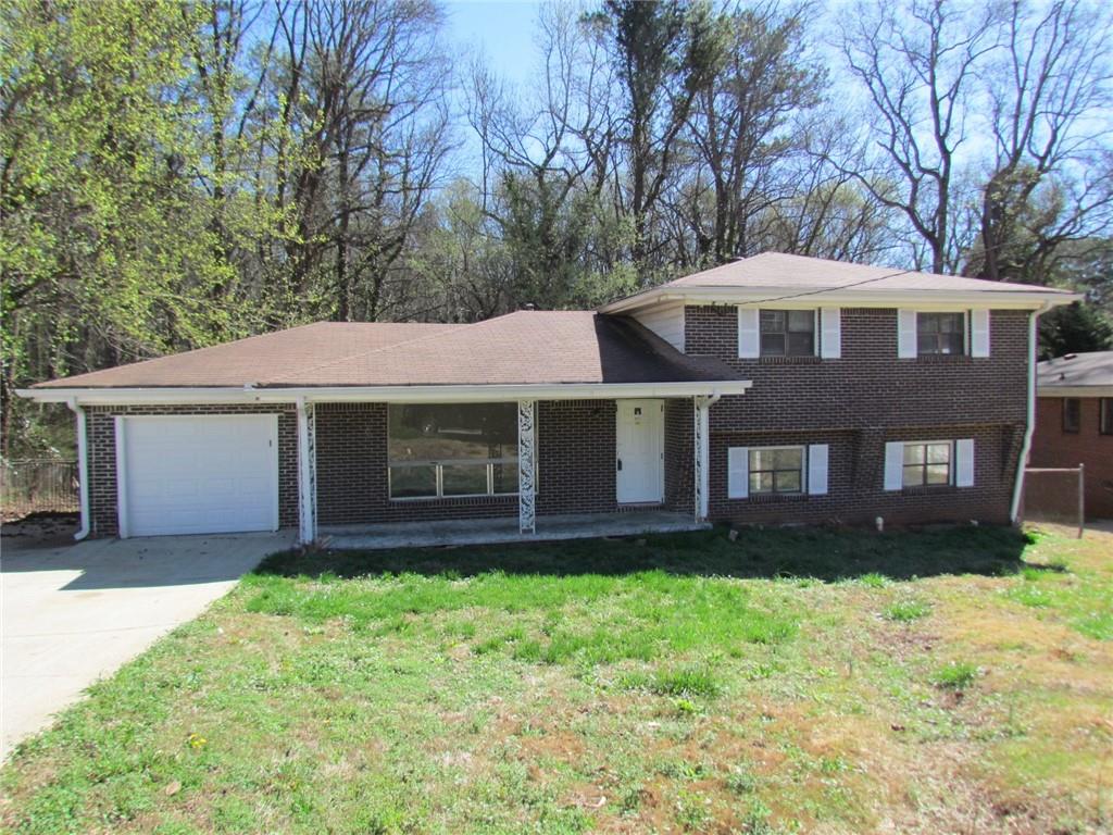 a front view of a house with a yard and porch