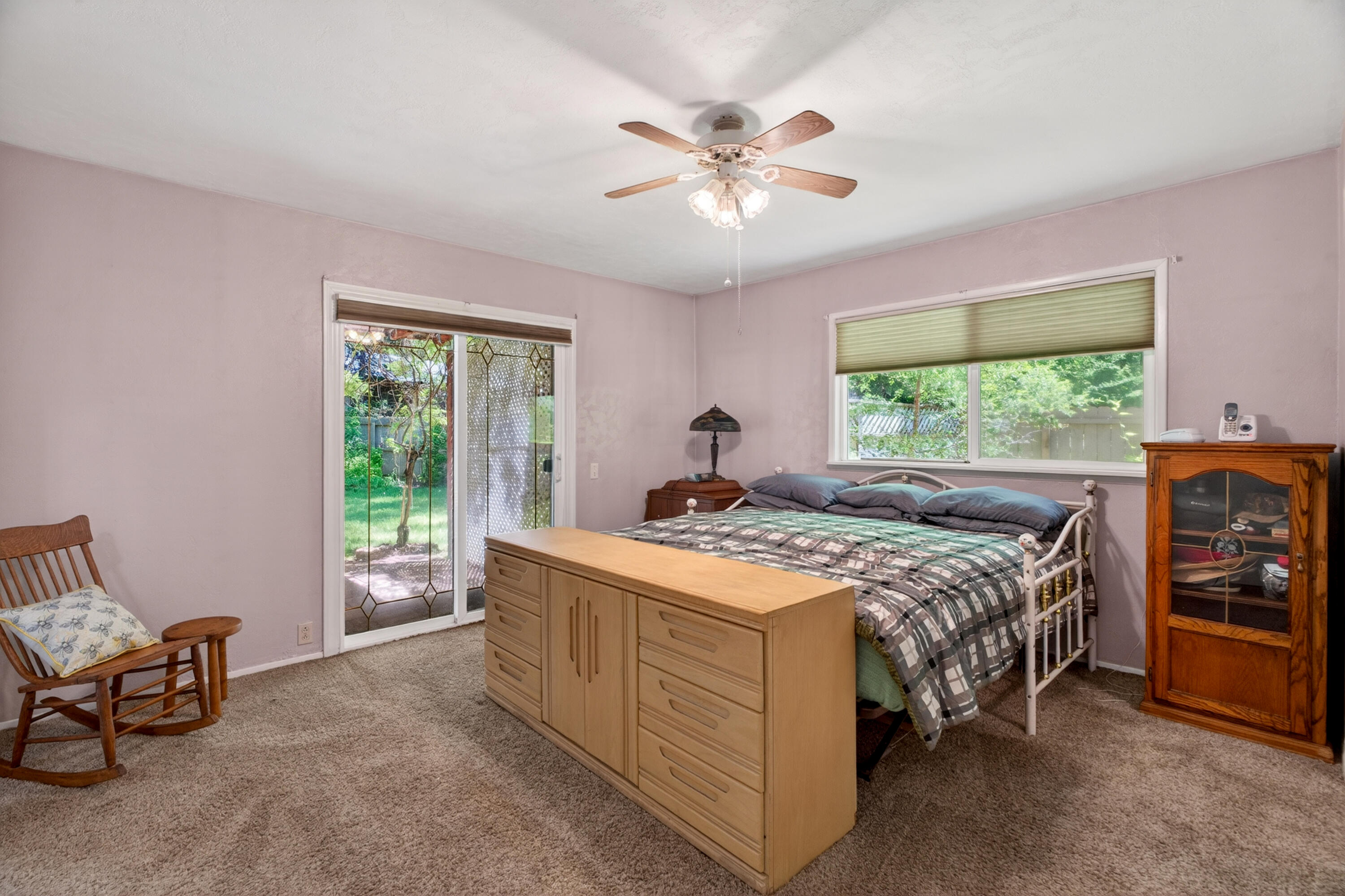 8015 Starlite Pines Road Shingletown, CA 96088 - Photo 20 of 38 a bedroom with a bed and a chandelier