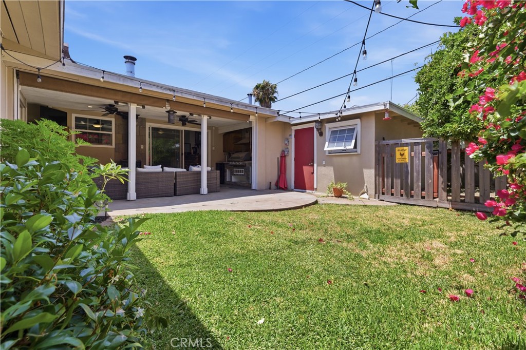 3327 North Studebaker Road Long Beach, CA 90808 - Photo 26 of 31 Plenty of grass area in the backyard, you can see the workshop here and then behind that gate is the chicken coop area