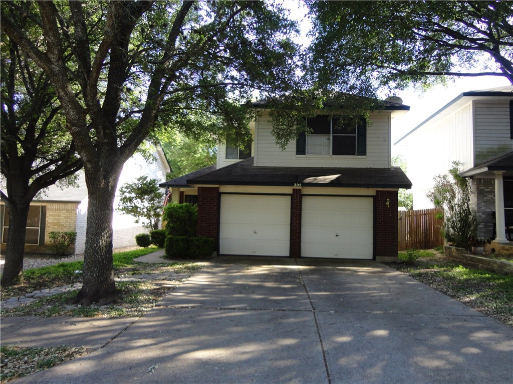 a house that has a tree in front of it