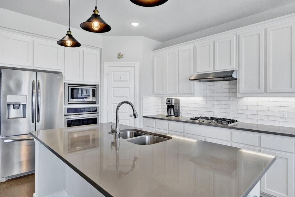 2044 Longbridge Road Forney, TX 75126 - Photo 13 of 40 a kitchen with stainless steel appliances granite countertop a sink a stove and a refrigerator
