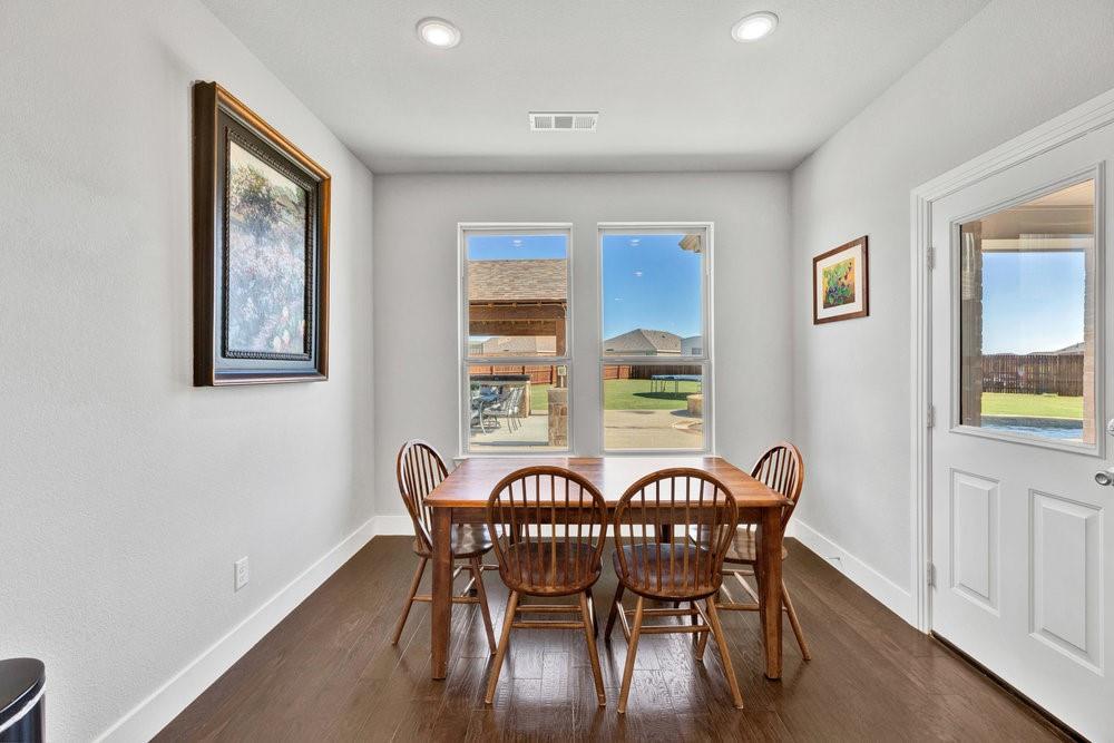 2044 Longbridge Road Forney, TX 75126 - Photo 14 of 40 a view of a dining room with furniture window and wooden floor