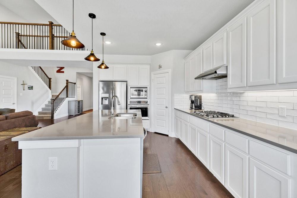 2044 Longbridge Road Forney, TX 75126 - Photo 15 of 40 a kitchen with stainless steel appliances granite countertop a stove and a sink