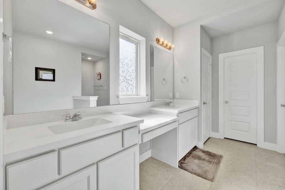 2044 Longbridge Road Forney, TX 75126 - Photo 18 of 40 a bathroom with a sink and a mirror