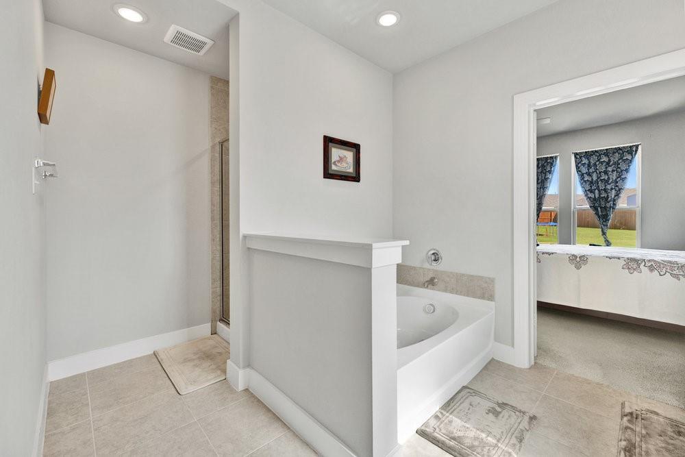2044 Longbridge Road Forney, TX 75126 - Photo 19 of 40 a bathroom with a tub sink and mirror