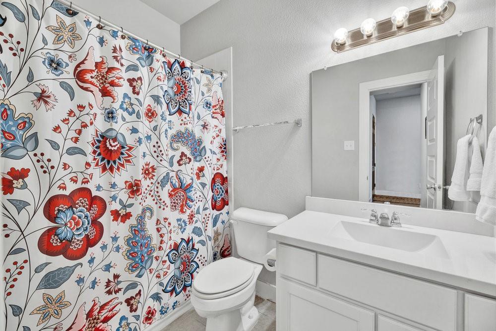 2044 Longbridge Road Forney, TX 75126 - Photo 21 of 40 a bathroom with a sink and mirror with toilet