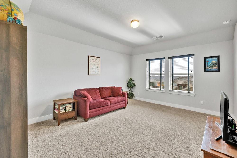 2044 Longbridge Road Forney, TX 75126 - Photo 23 of 40 a living room with furniture and a flat screen tv