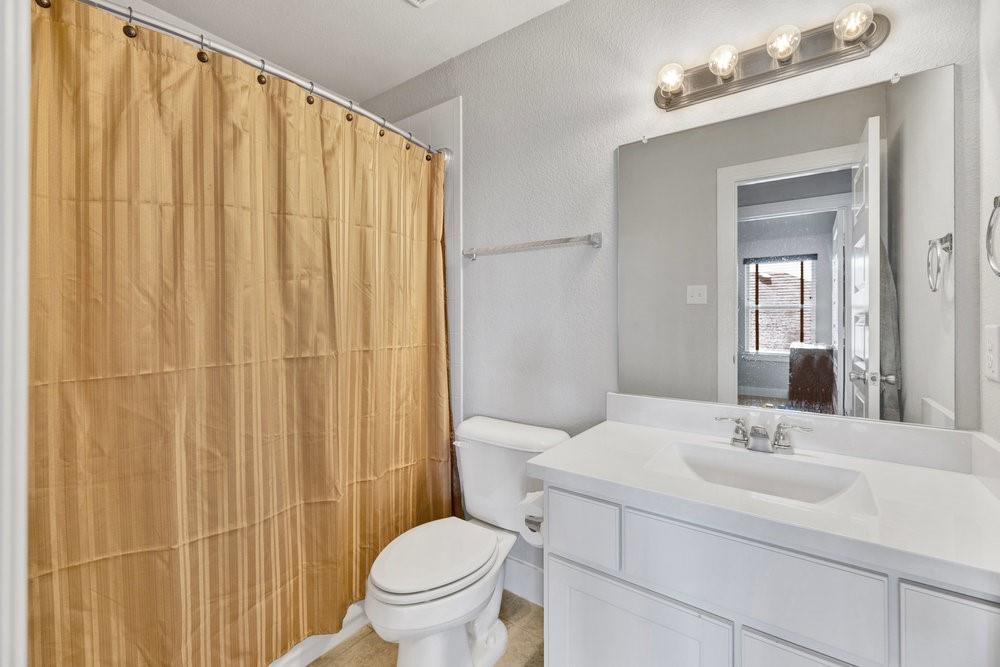 2044 Longbridge Road Forney, TX 75126 - Photo 25 of 40 a bathroom with a sink toilet and shower