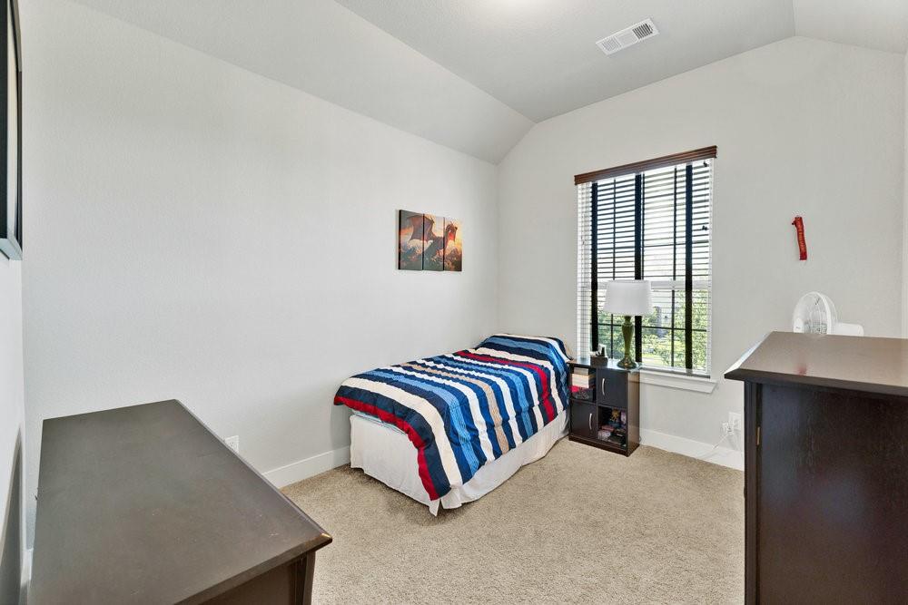 2044 Longbridge Road Forney, TX 75126 - Photo 28 of 40 a bedroom with a bed and window