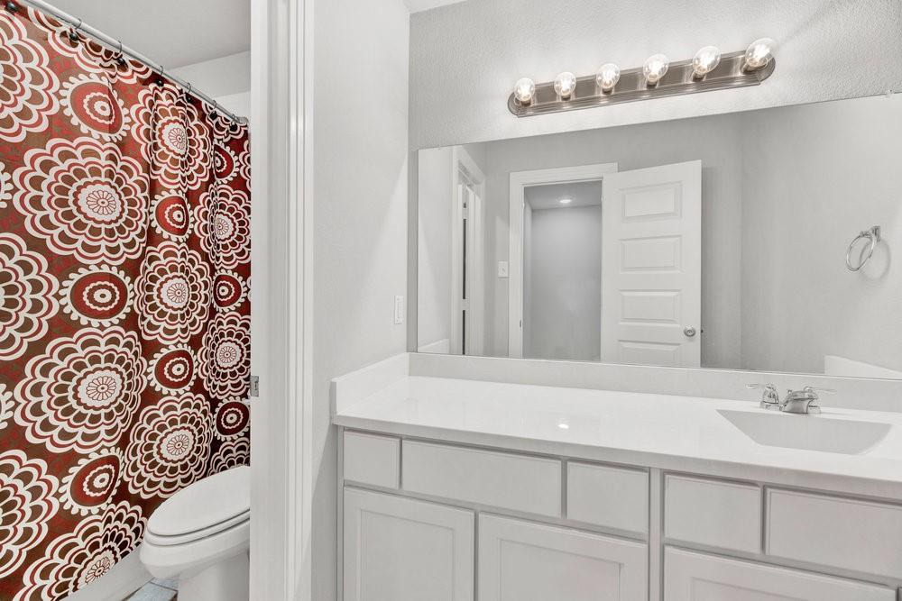 2044 Longbridge Road Forney, TX 75126 - Photo 29 of 40 a bathroom with a sink and a mirror