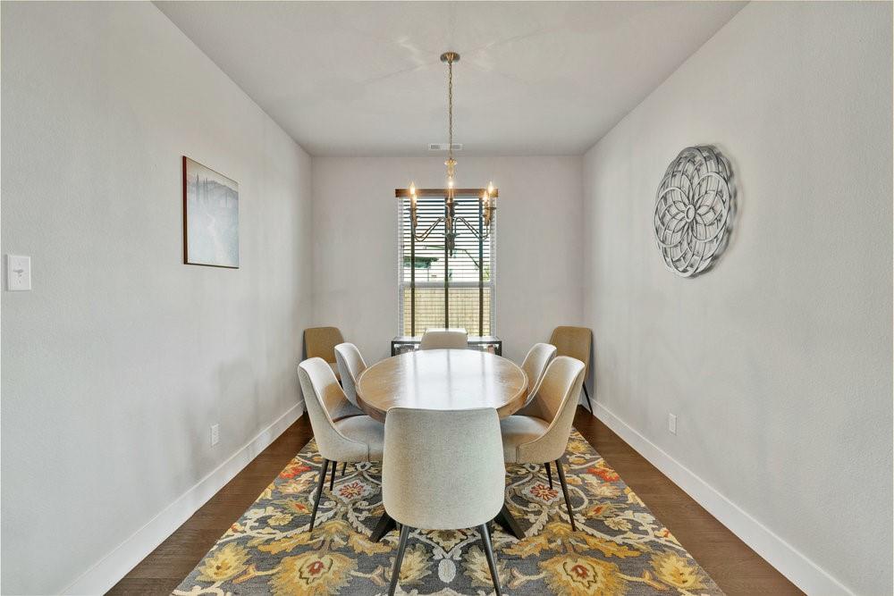 2044 Longbridge Road Forney, TX 75126 - Photo 7 of 40 a dining room with furniture a rug and wooden floor