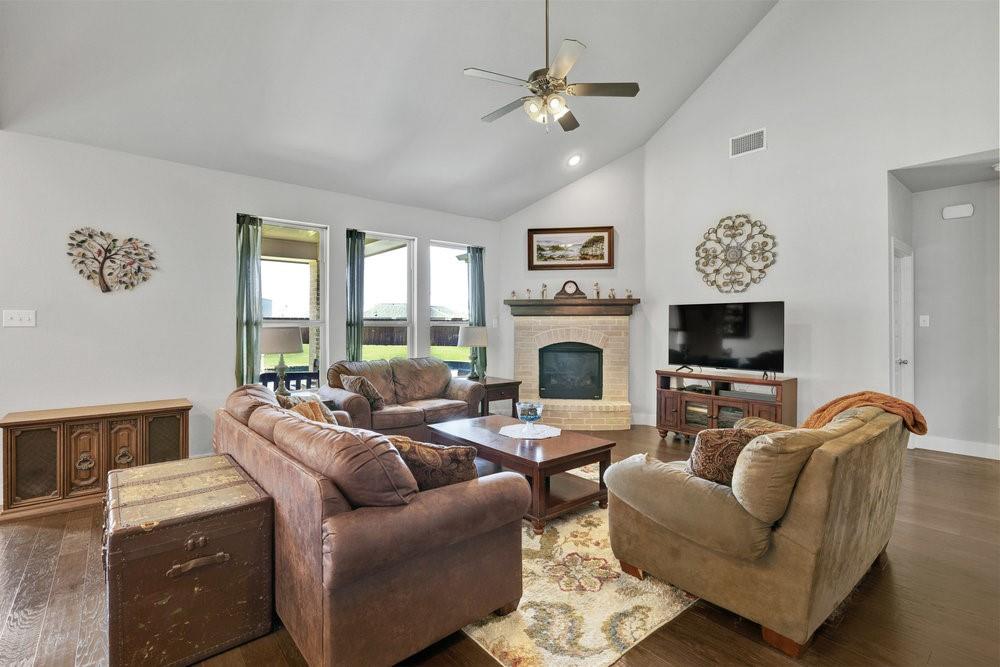 2044 Longbridge Road Forney, TX 75126 - Photo 8 of 40 a living room with furniture a fireplace and a flat screen tv