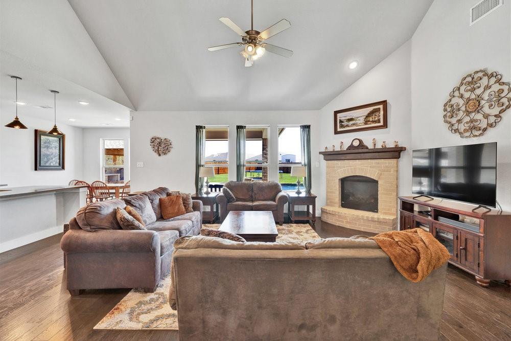 2044 Longbridge Road Forney, TX 75126 - Photo 9 of 40 a living room with furniture a flat screen tv and a fireplace