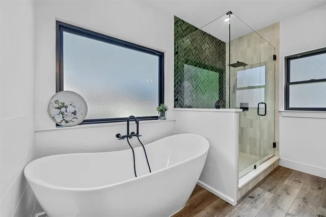 a bathroom with a tub and a shower
