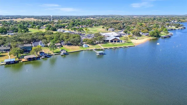 an aerial view of residential houses with outdoor space and river