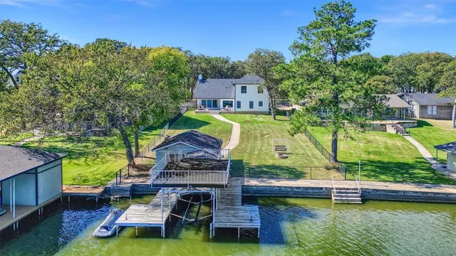 an aerial view of a house with a large pool