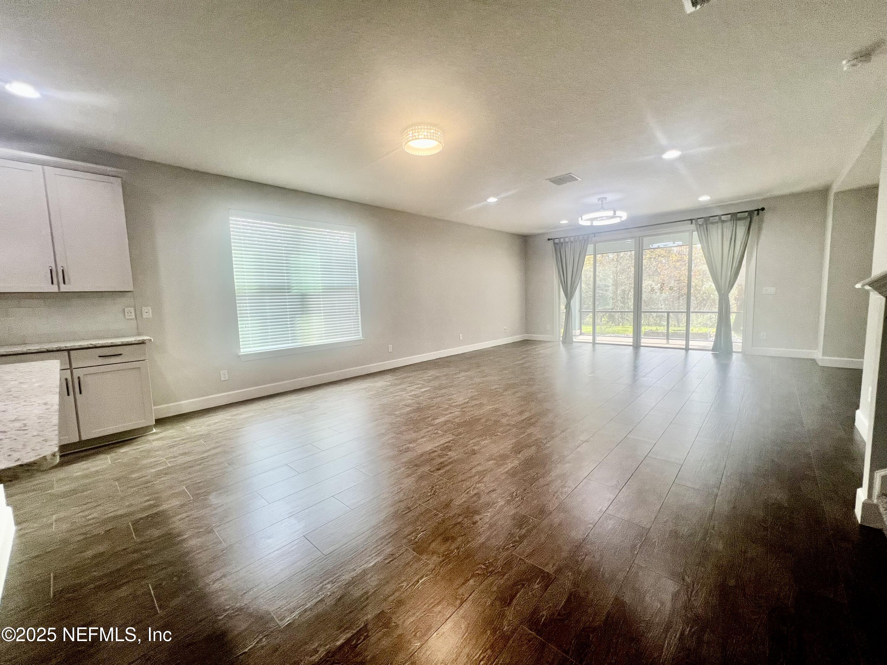 242 Orchard Lane St. Augustine, FL 32095 - Photo 12 of 44 a view of an empty room with wooden floor and a window