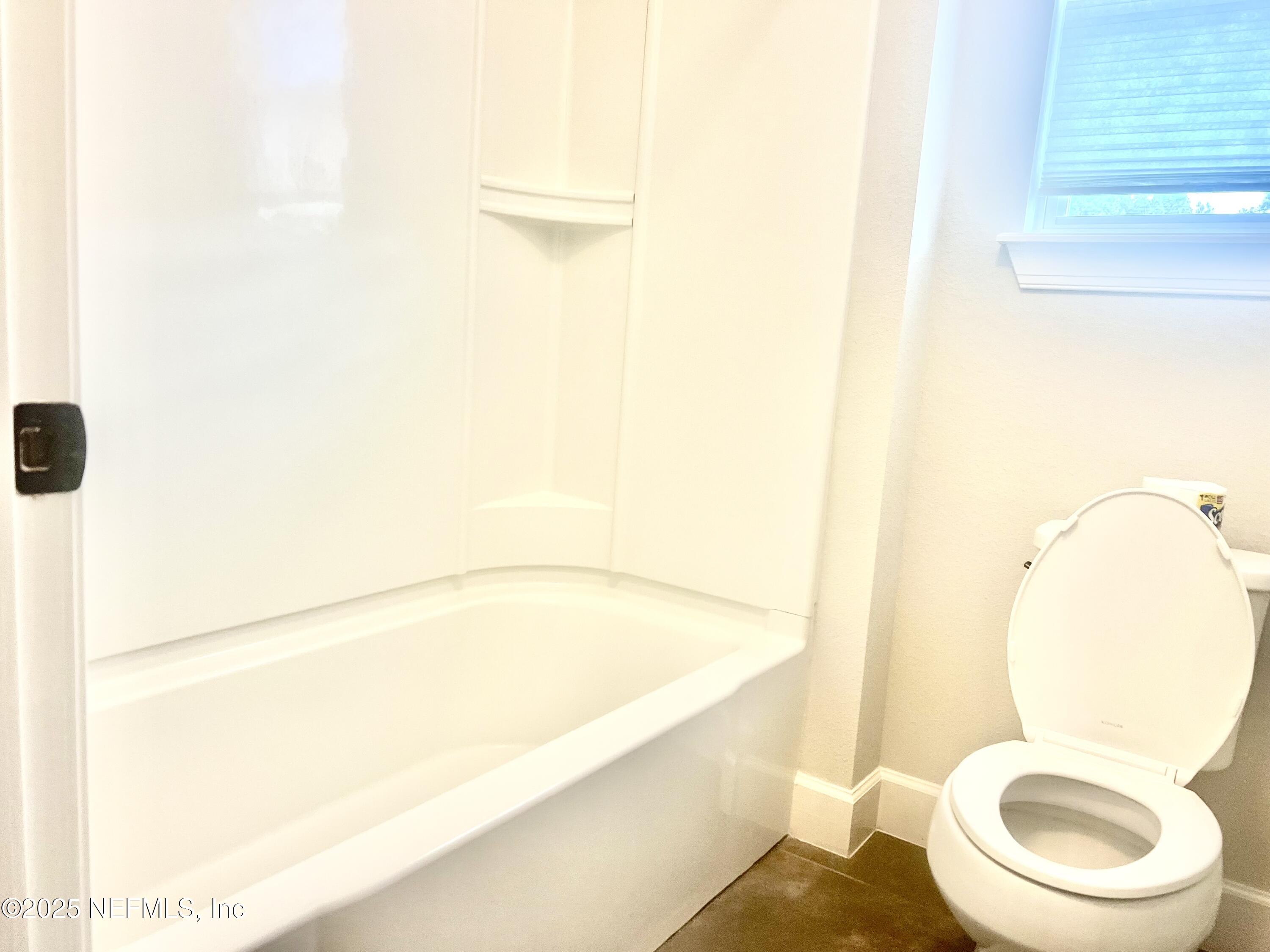 242 Orchard Lane St. Augustine, FL 32095 - Photo 33 of 44 a white toilet sitting next to a bathroom sink