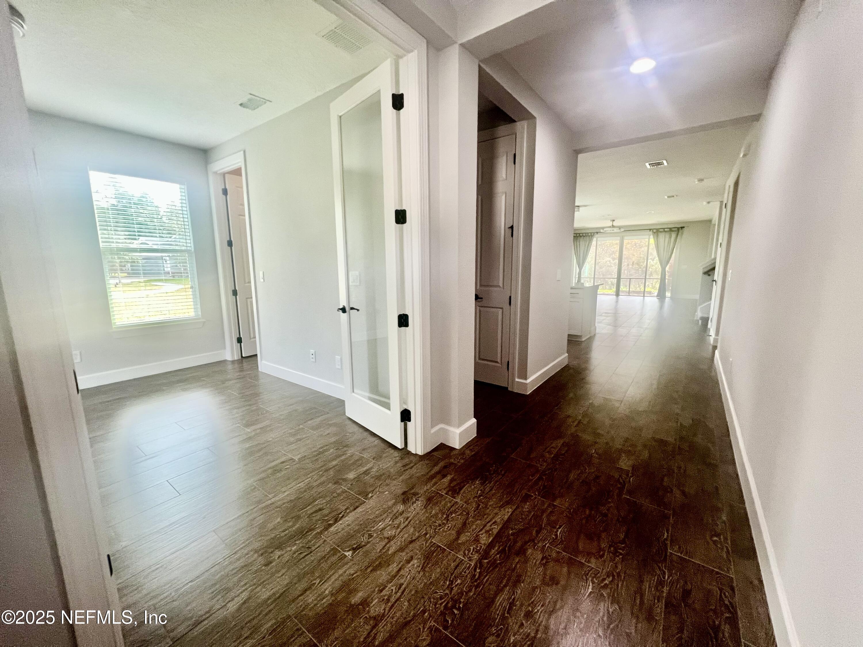 242 Orchard Lane St. Augustine, FL 32095 - Photo 5 of 44 a view of a hallway with wooden floor and closet area