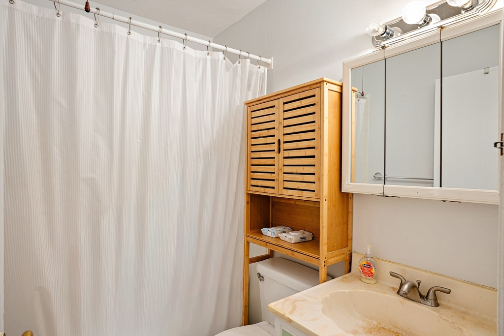 10 Scottfield Road, Unit 34 Boston, MA 02134 - Photo 11 of 19 a bathroom with a sink and a mirror