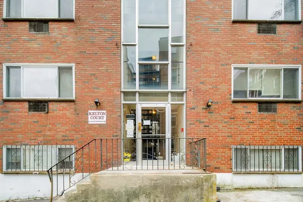 a brick building with a door and a window