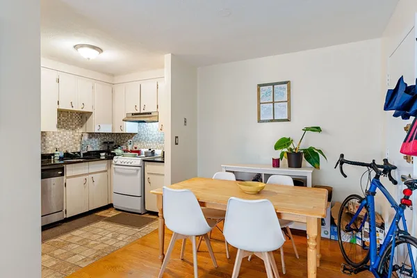 a view of a dining room with furniture and a kitchen