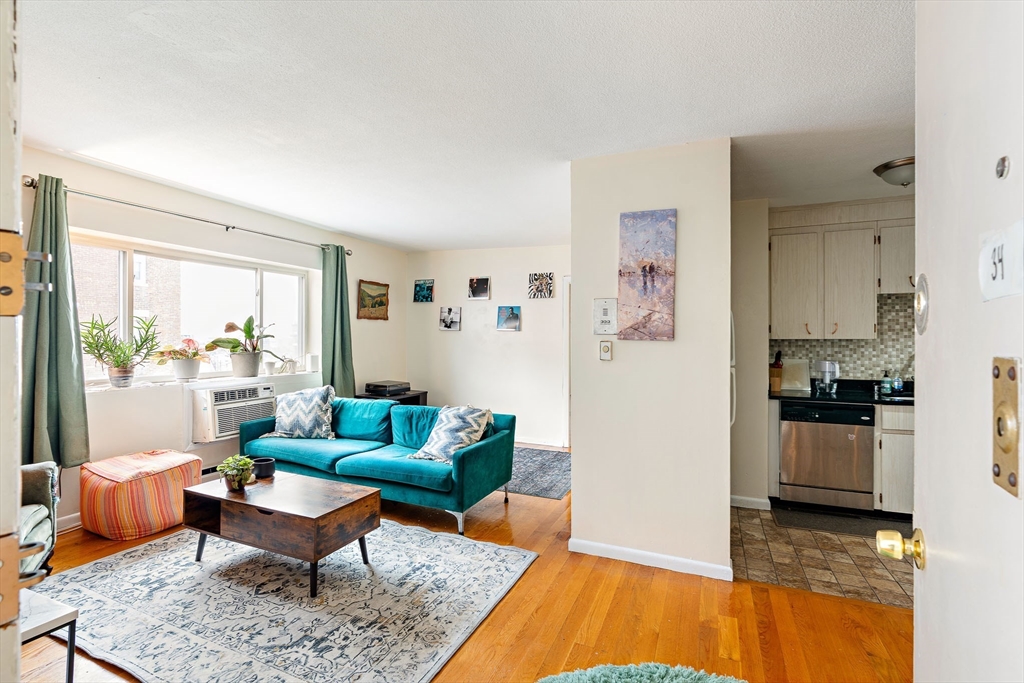 10 Scottfield Road, Unit 34 Boston, MA 02134 - Photo 9 of 19 a living room with furniture and a rug