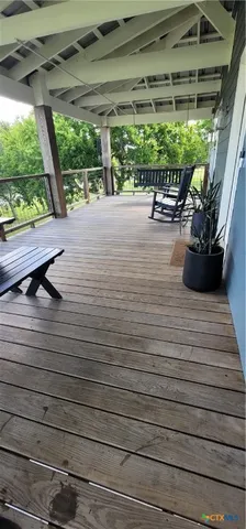 a roof deck with wooden floor