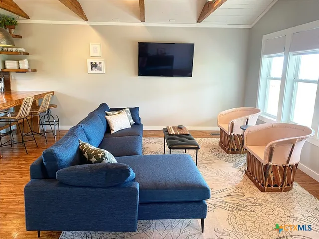 a living room with furniture and kitchen view
