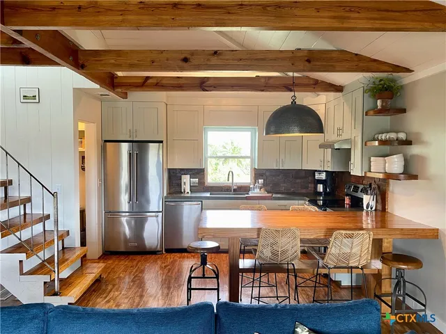 a kitchen with a sink a stove and a cabinets