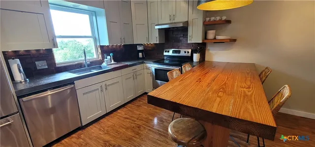 a view of kitchen cabinet and window