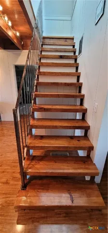 a bedroom with two beds and large windows