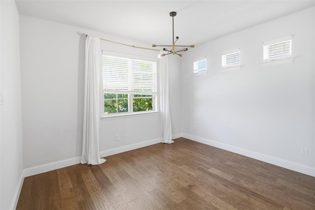7416 Sequoia Rdg Road Little Elm, TX 76227 - Photo 11 of 37 Bright interior space featuring wood-finish flooring, white baseboards, and a modern chandelier